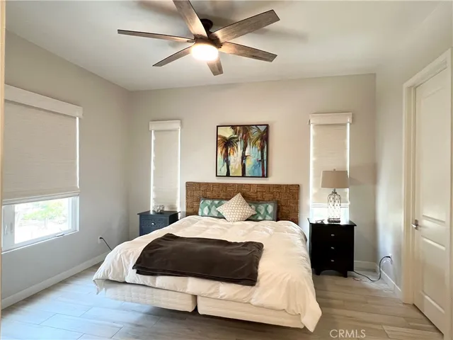 a bedroom with a large bed and a chandelier