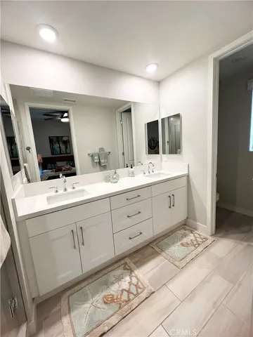 a spacious bathroom with double vanity sink and mirror