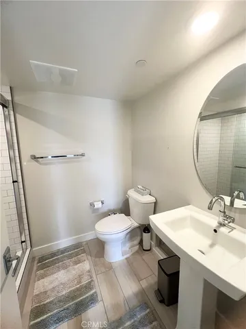 a bathroom with a sink toilet and a mirror