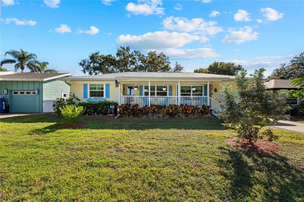1109 Commodore Street Clearwater, FL 33755 - Photo 1 of 42 a front view of a house with swimming pool having outdoor seating