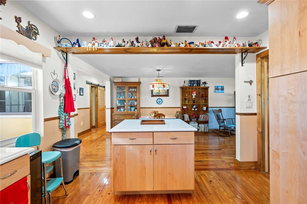 1109 Commodore Street Clearwater, FL 33755 - Photo 12 of 42 a very nice looking room with a dining table chairs and couches