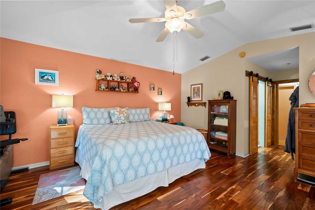 1109 Commodore Street Clearwater, FL 33755 - Photo 20 of 42 a bedroom with a large bed and a chandelier