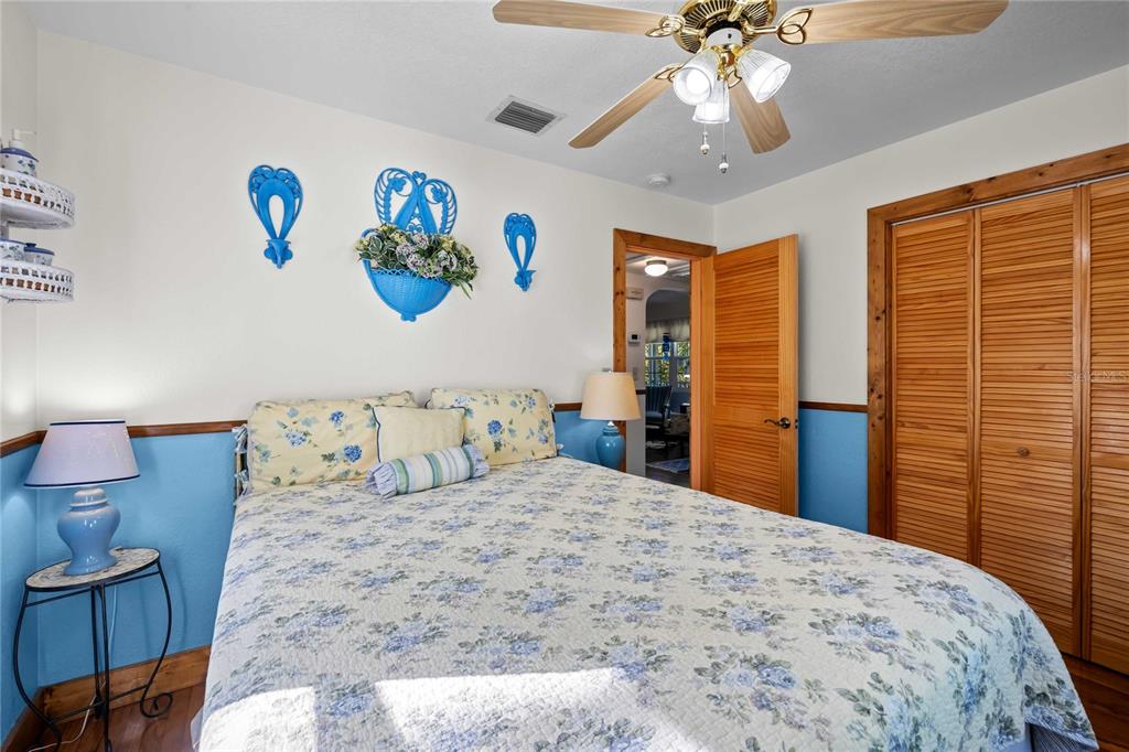 1109 Commodore Street Clearwater, FL 33755 - Photo 25 of 42 a bedroom with a bed and a chandelier
