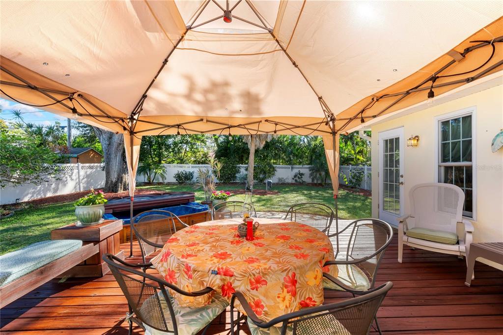 1109 Commodore Street Clearwater, FL 33755 - Photo 31 of 42 a view of a patio with a table chairs and a backyard