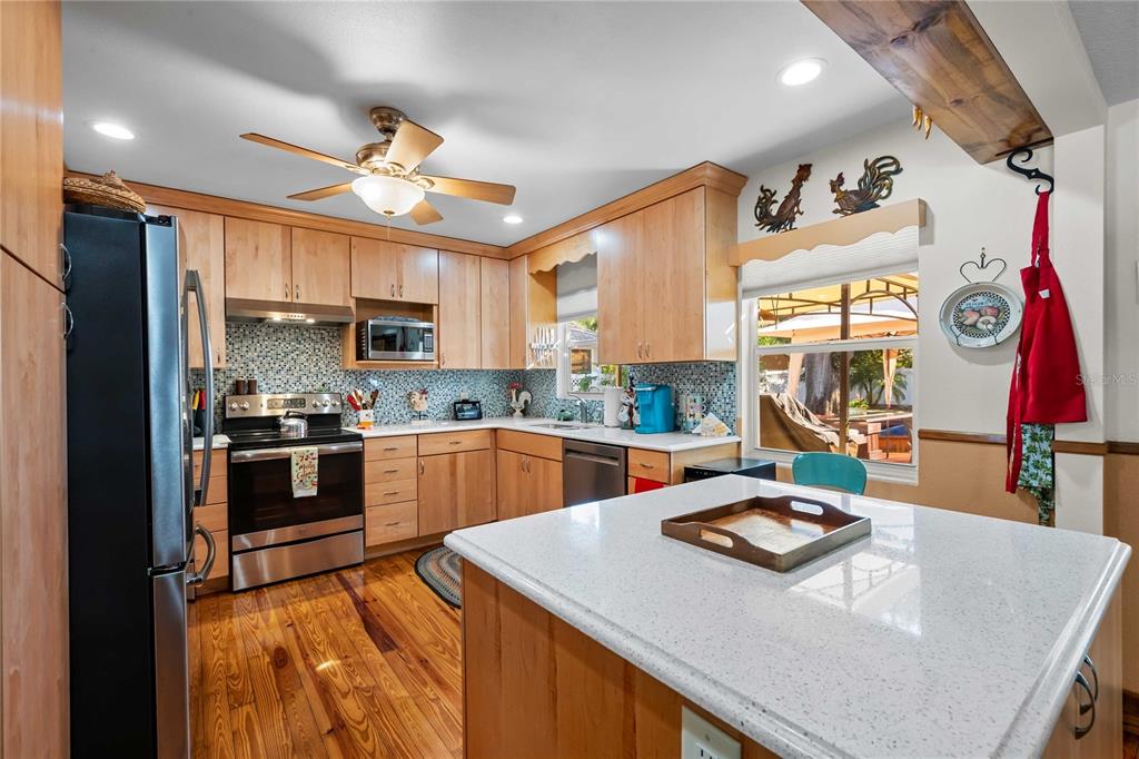 1109 Commodore Street Clearwater, FL 33755 - Photo 6 of 42 a kitchen with stainless steel appliances granite countertop a sink a stove and a refrigerator