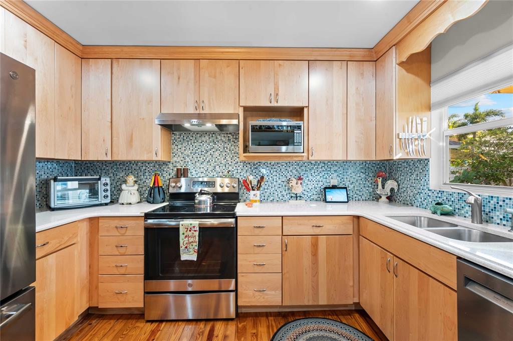 1109 Commodore Street Clearwater, FL 33755 - Photo 8 of 42 a kitchen with stainless steel appliances granite countertop a stove a sink and a microwave