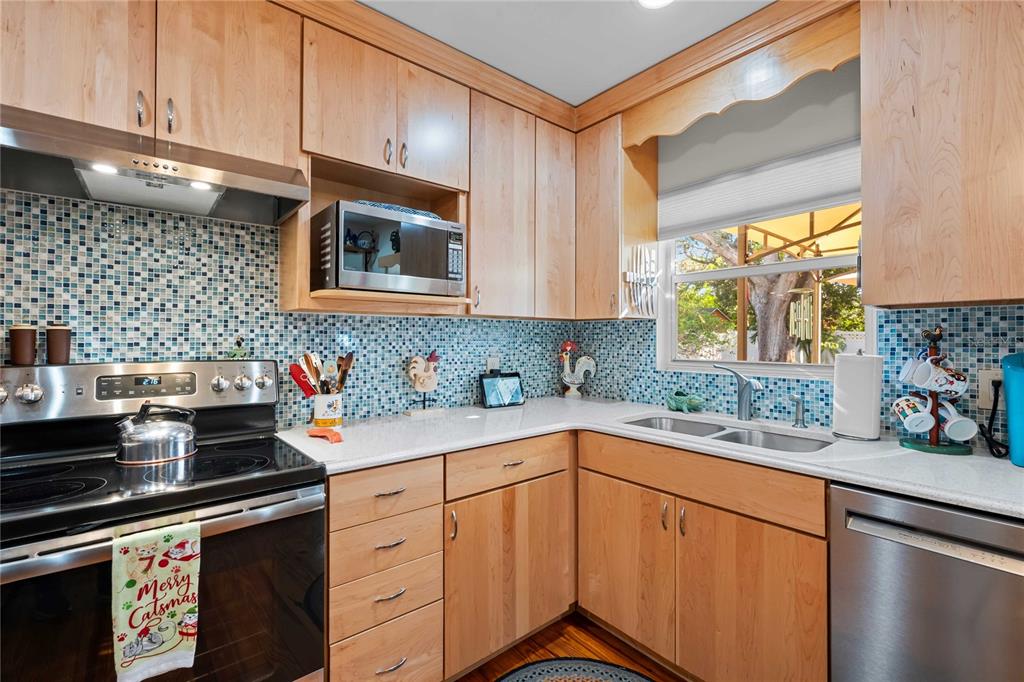 1109 Commodore Street Clearwater, FL 33755 - Photo 10 of 42 a kitchen with stainless steel appliances a sink stove and cabinets