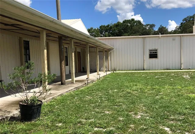 a backyard of a house with yard and outdoor seating