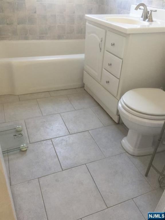 418 Main Street, Unit D6 Fort Lee, NJ 07024 - Photo 7 of 7 a bathroom with a sink a toilet and bathtub