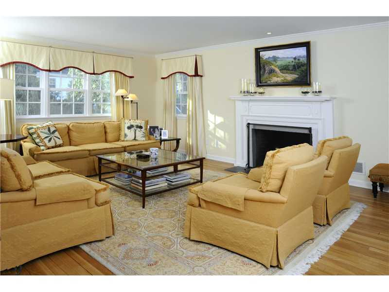 Undisclosed Address Riverside, CT 06878 - Photo 2 of 19 a living room with furniture a fireplace and a flat screen tv