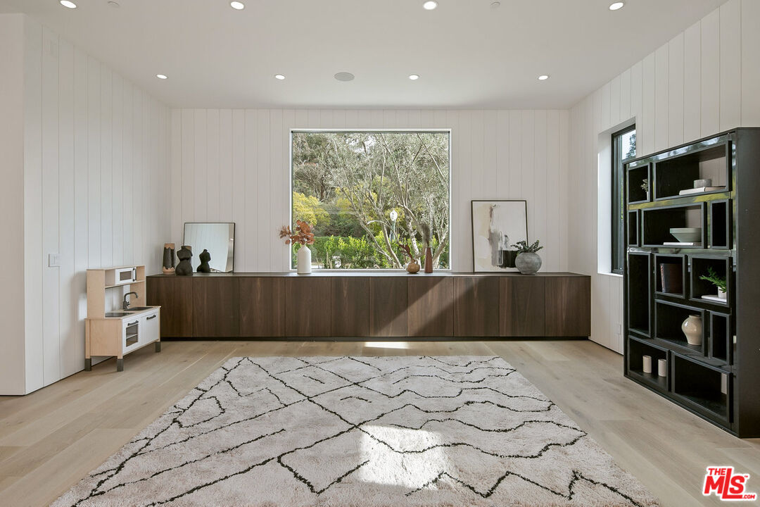 211 Veteran Avenue Los Angeles, CA 90024 - Photo 14 of 51 a living room with a large window and a book shelf