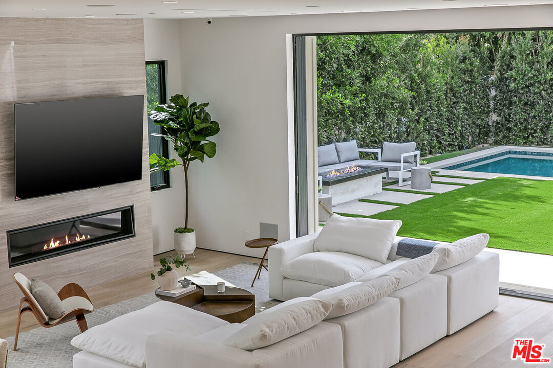 211 Veteran Avenue Los Angeles, CA 90024 - Photo 19 of 51 a living room with furniture fireplace and flat screen tv