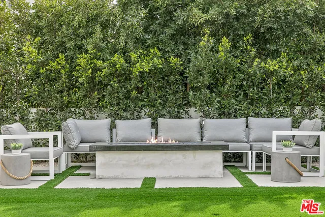 a view of house with a yard and sitting area