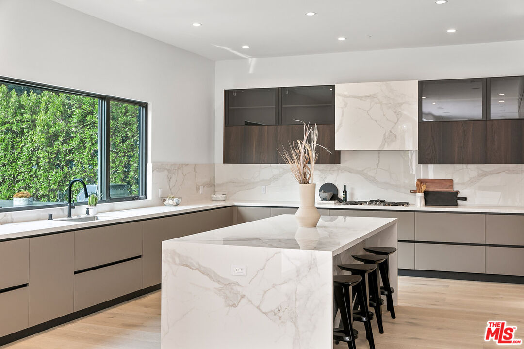 211 Veteran Avenue Los Angeles, CA 90024 - Photo 23 of 51 a kitchen with a sink a stove a refrigerator and a stove top oven