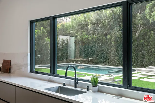 a view of a sink and a table and chair in a room