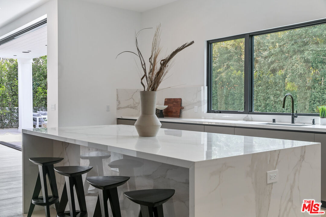 211 Veteran Avenue Los Angeles, CA 90024 - Photo 28 of 51 a view of a sink and a table and chair in a room