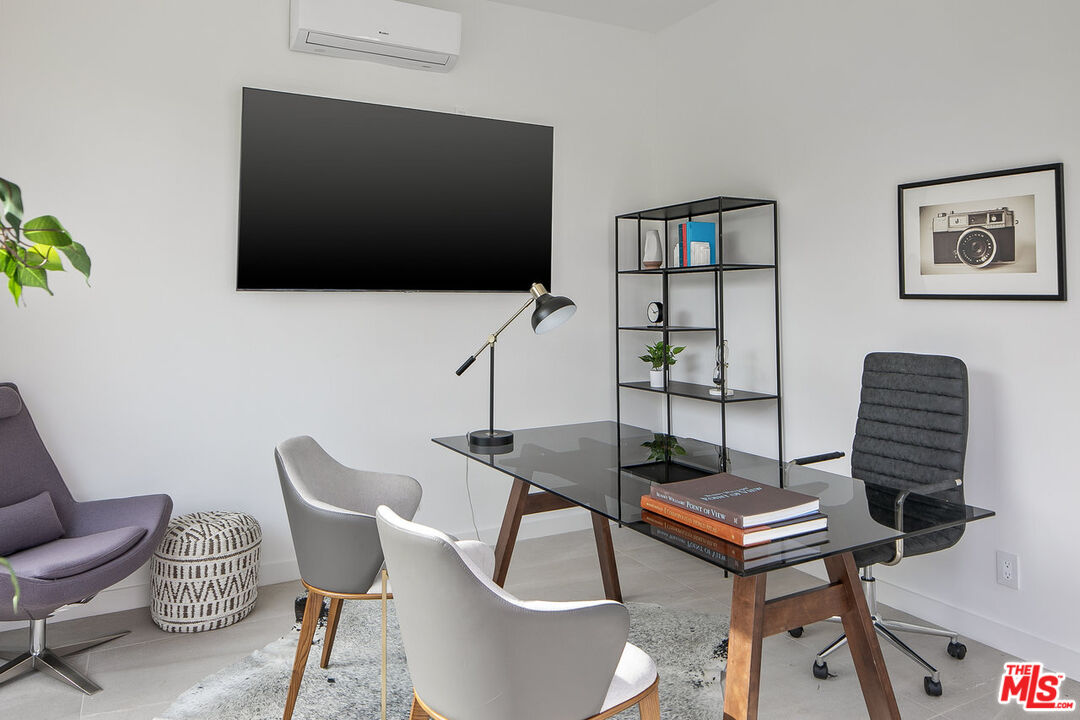 211 Veteran Avenue Los Angeles, CA 90024 - Photo 36 of 51 a living room with furniture and a flat screen tv