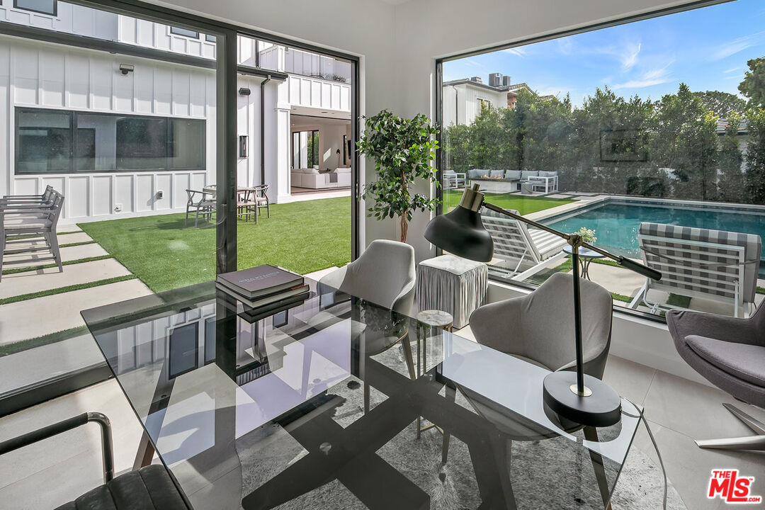211 Veteran Avenue Los Angeles, CA 90024 - Photo 37 of 51 a view of a patio with couches chairs potted plants and a palm tree
