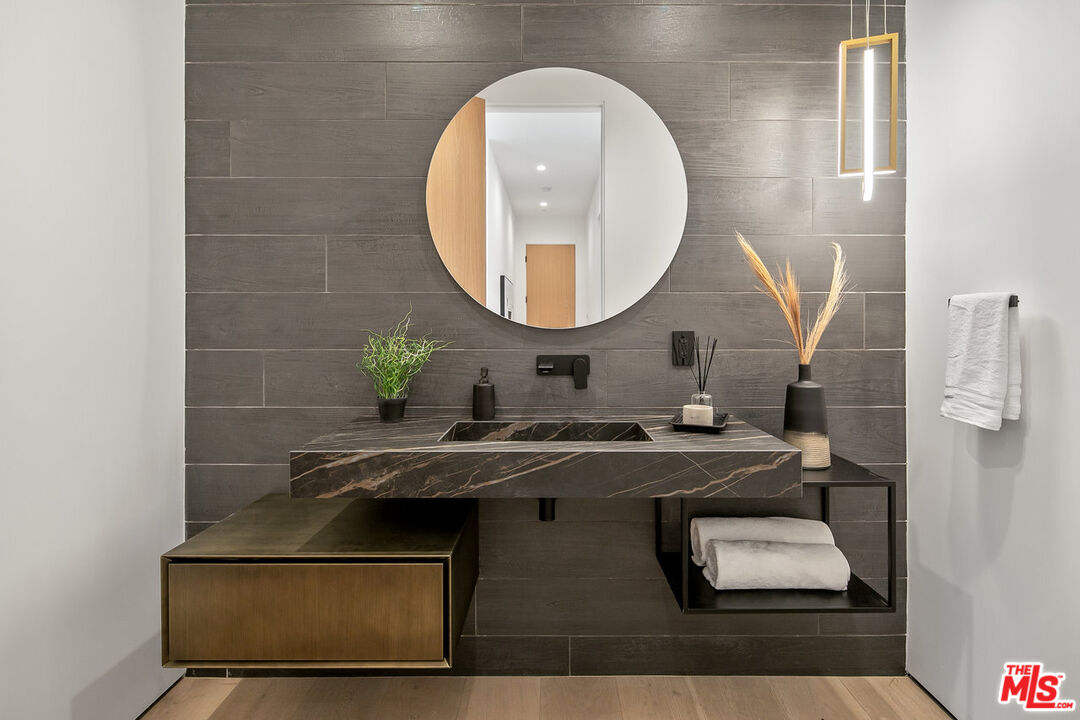 211 Veteran Avenue Los Angeles, CA 90024 - Photo 44 of 51 a bathroom with a sink and a mirror