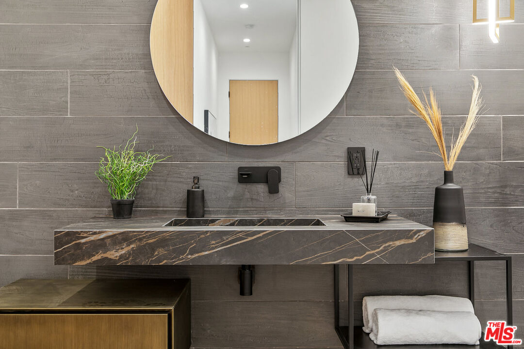 211 Veteran Avenue Los Angeles, CA 90024 - Photo 45 of 51 a bathroom with a sink a toilet and mirror