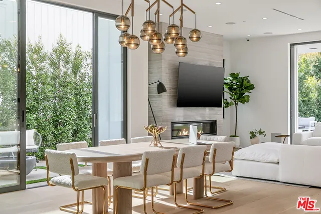 a dining room with furniture a chandelier and wooden floor