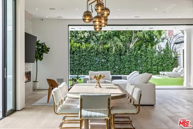 a dining room with furniture and a floor to ceiling window