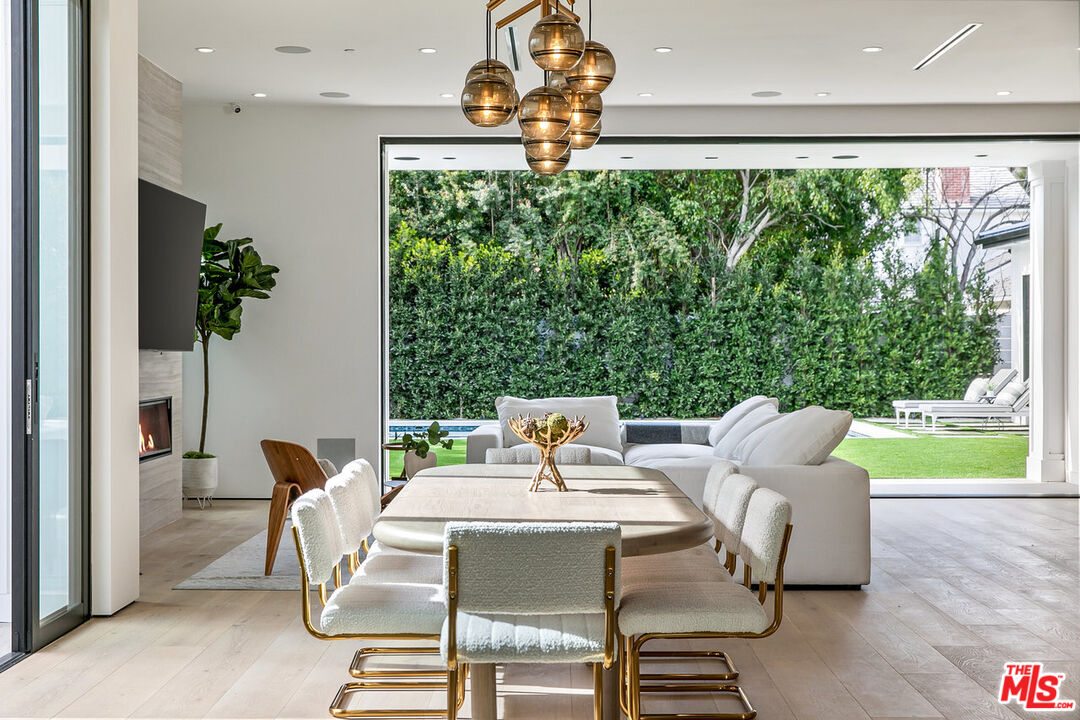 211 Veteran Avenue Los Angeles, CA 90024 - Photo 9 of 51 a dining room with furniture and a floor to ceiling window