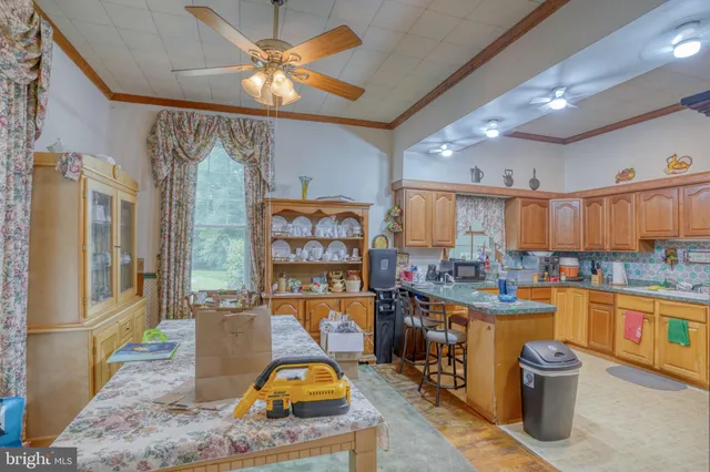 a room with stainless steel appliances kitchen island granite countertop a stove and a sink