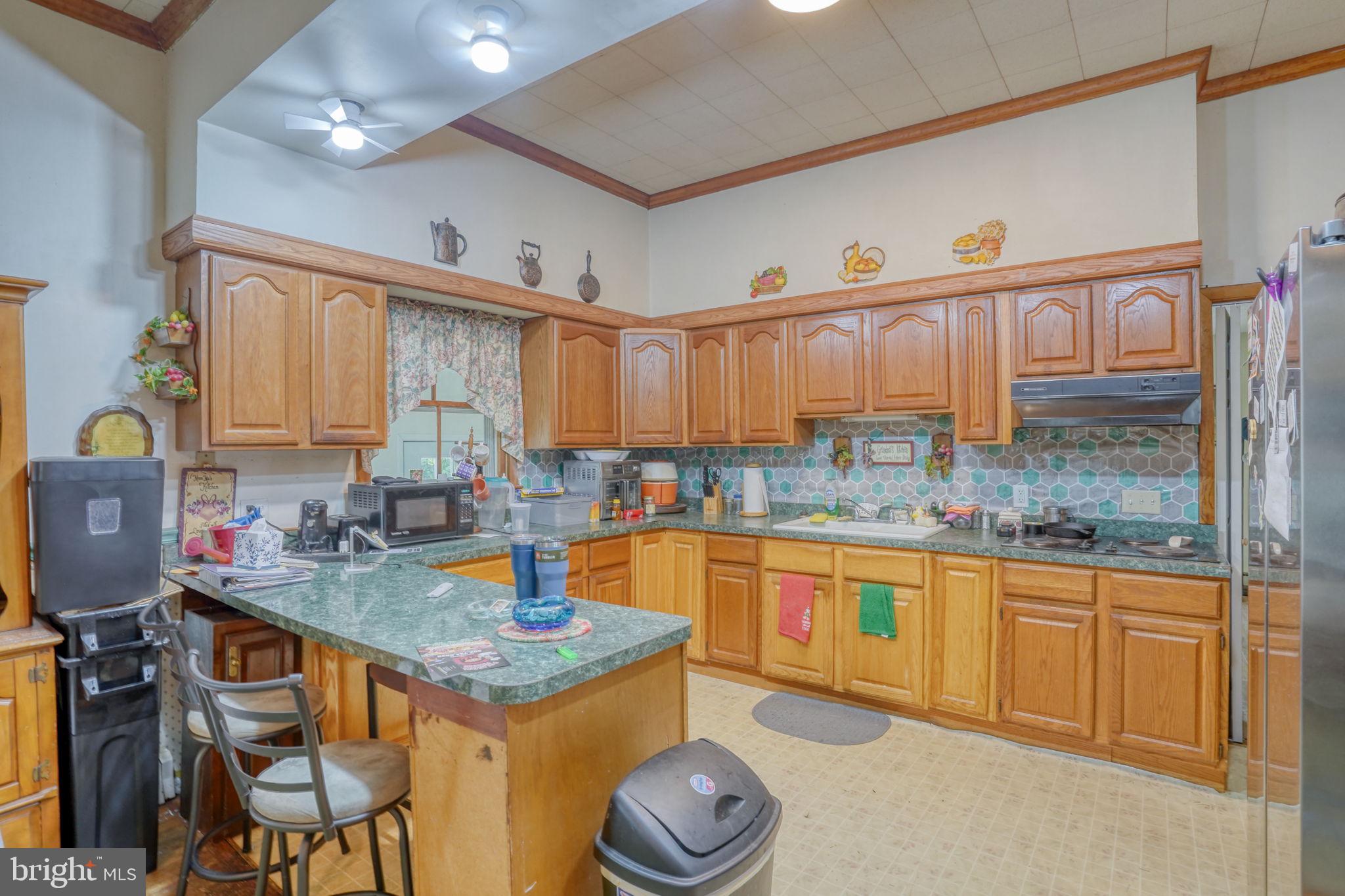 5321 Millington Road Clayton, DE 19938 - Photo 28 of 44 a kitchen with stainless steel appliances granite countertop a sink and cabinets