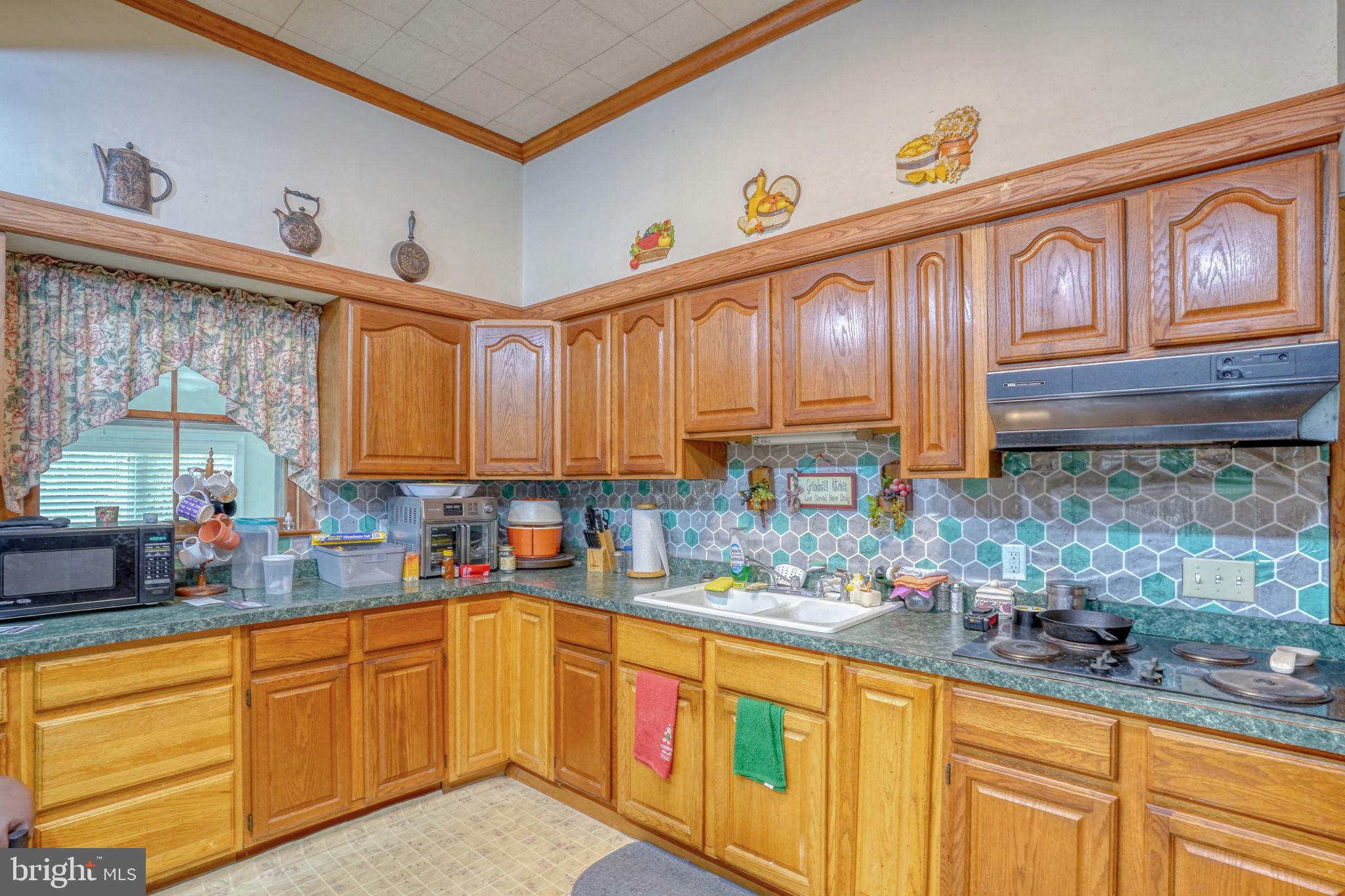 5321 Millington Road Clayton, DE 19938 - Photo 29 of 44 a kitchen with stainless steel appliances granite countertop a sink a stove and cabinets