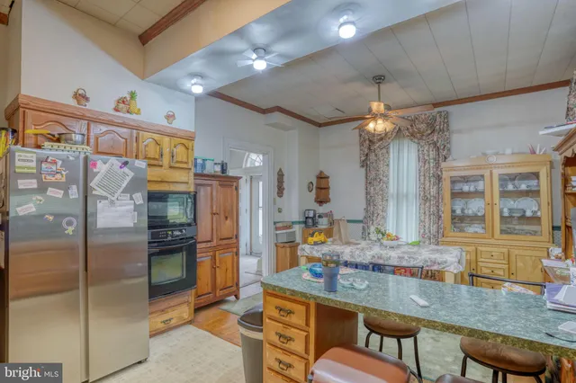 a kitchen with stainless steel appliances granite countertop a refrigerator and a stove