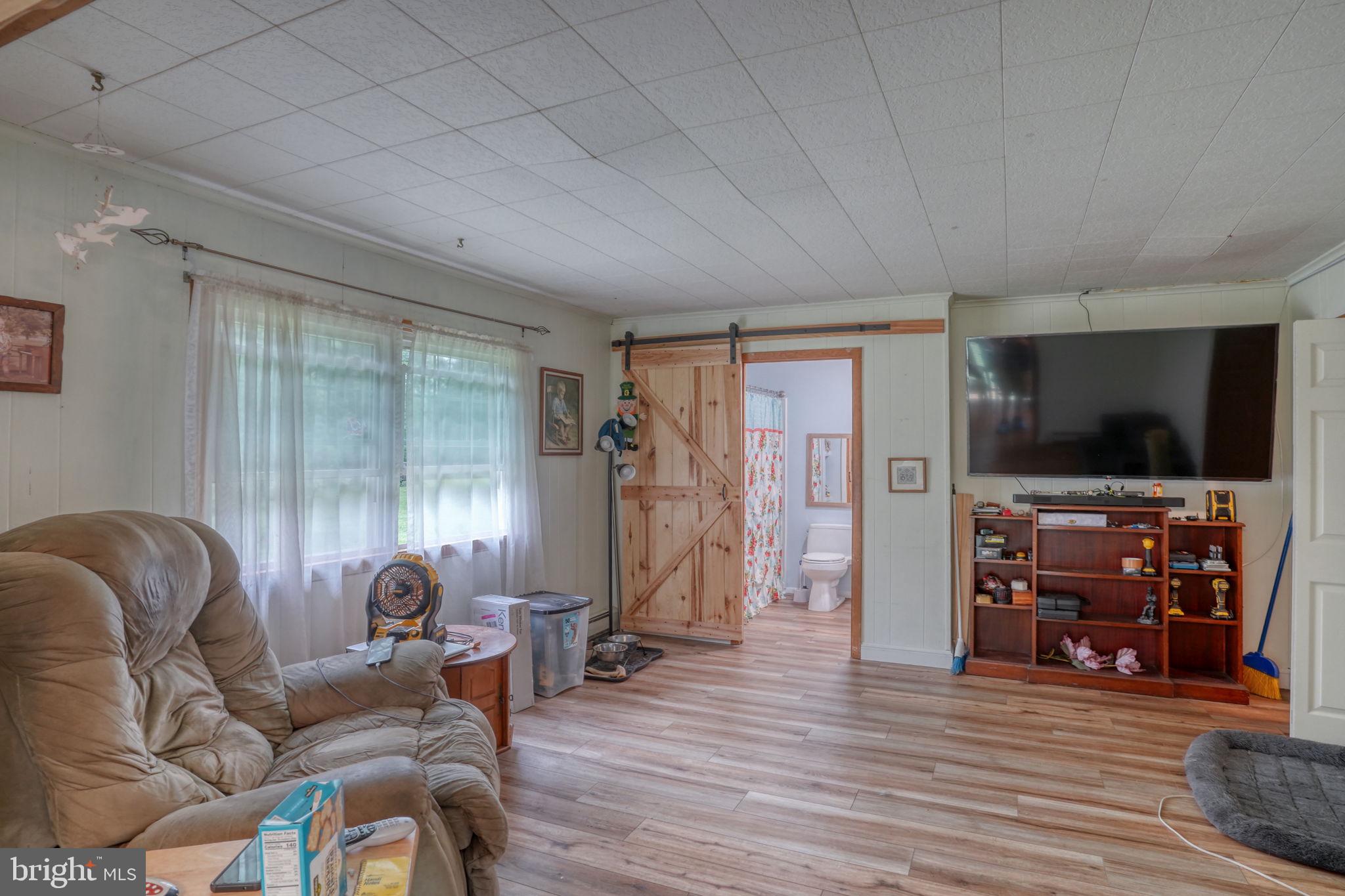 5321 Millington Road Clayton, DE 19938 - Photo 34 of 44 a living room with furniture and a flat screen tv