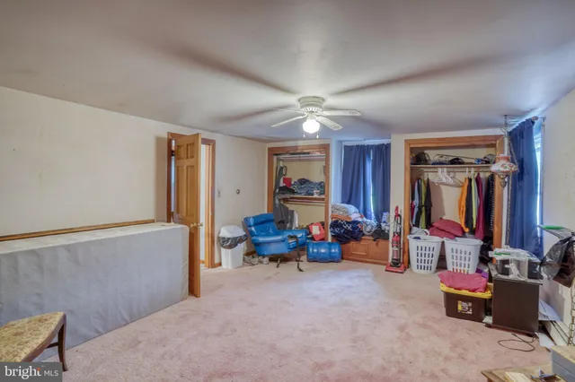 a view of a livingroom with workspace and a window