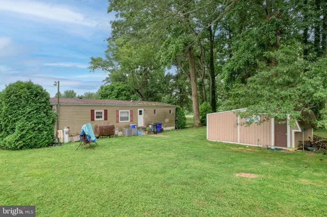 a view of a house with a yard and sitting area