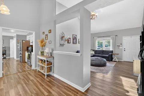 a living room with furniture and a wooden floor