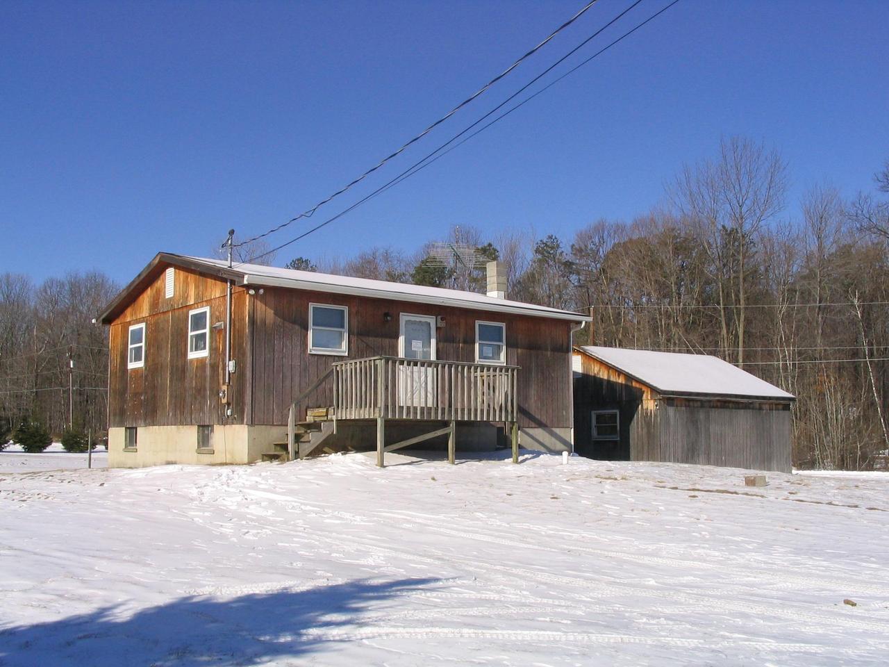 8122 Cays Road Stroudsburg, PA 18360 - Photo 1 of 3 a front view of a house with a yard