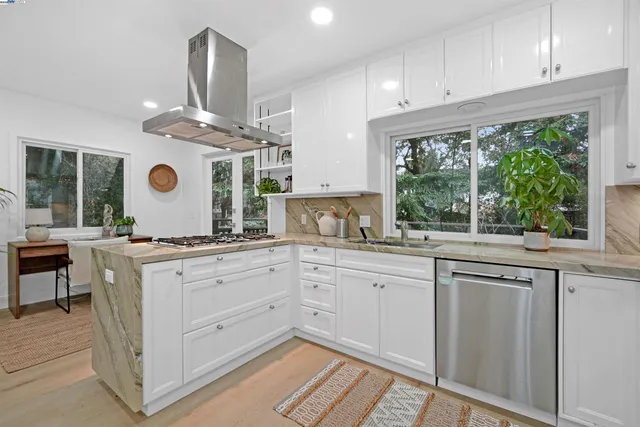 a large white kitchen with a large window