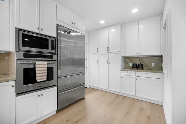 a view of a hallway with a livingroom and a bathroom