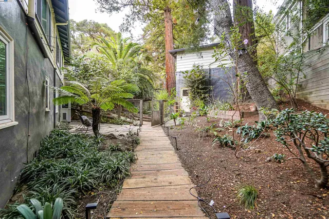 an aerial view of a house a garden and mountain view in back