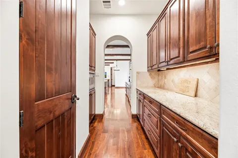 a view of a kitchen with wooden floor and staircase