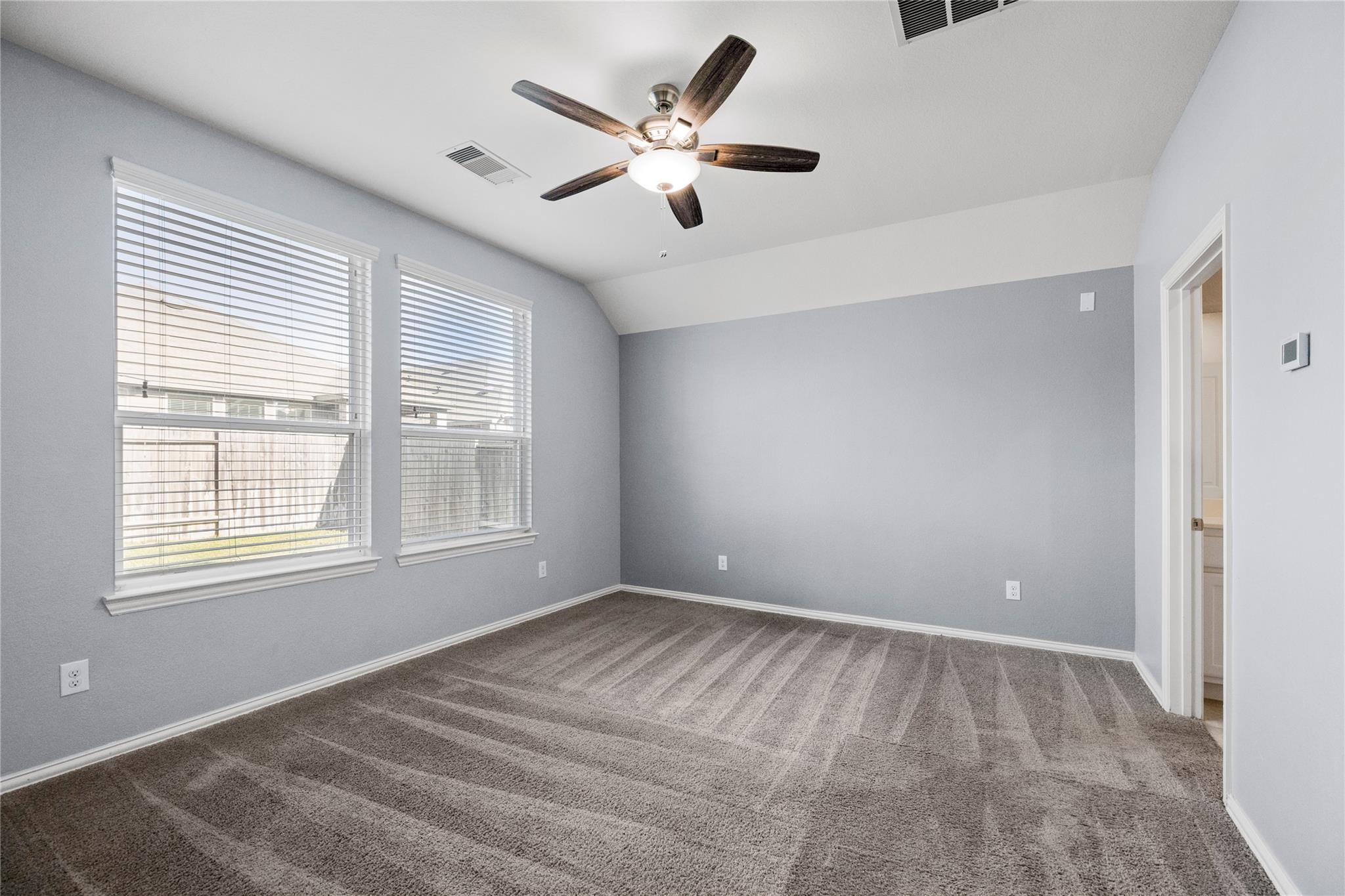 29507 Whitebrush Trace Drive Spring, TX 77386 - Photo 8 of 32 Secondary bedroom with window, ceiling fan, and wood-look flooring.