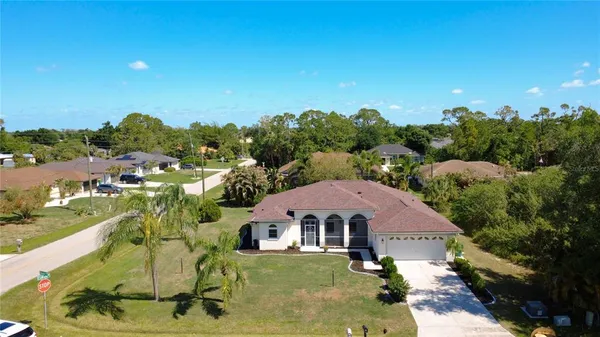 a view of a big house with a big yard