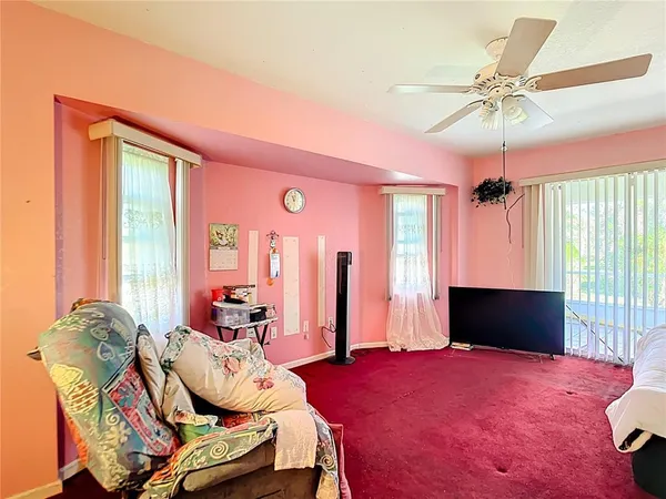 a bedroom with a bed and a view of kitchen