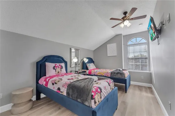 a view of a livingroom with bed and mirror
