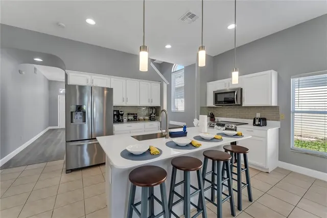 a kitchen with refrigerator and cabinets