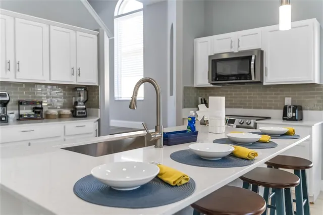 a kitchen with a dining table and chairs