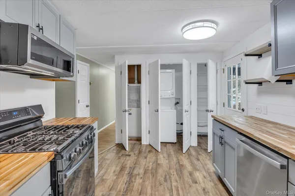 a kitchen with stainless steel appliances granite countertop a stove and a sink