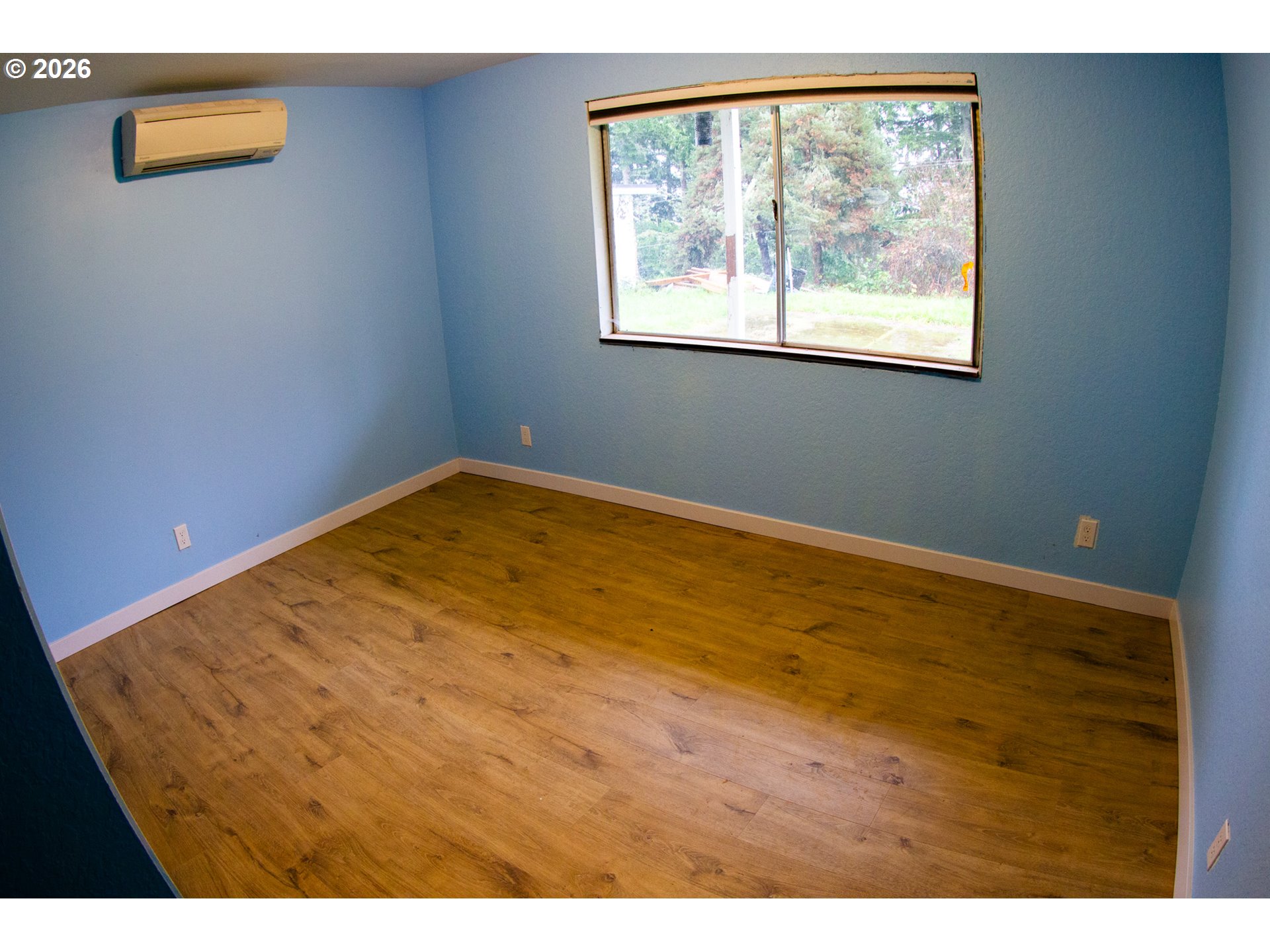 411 Upper Terrace Lane Glide, OR 97443 - Photo 11 of 25 a view of empty room with wooden floor and fan