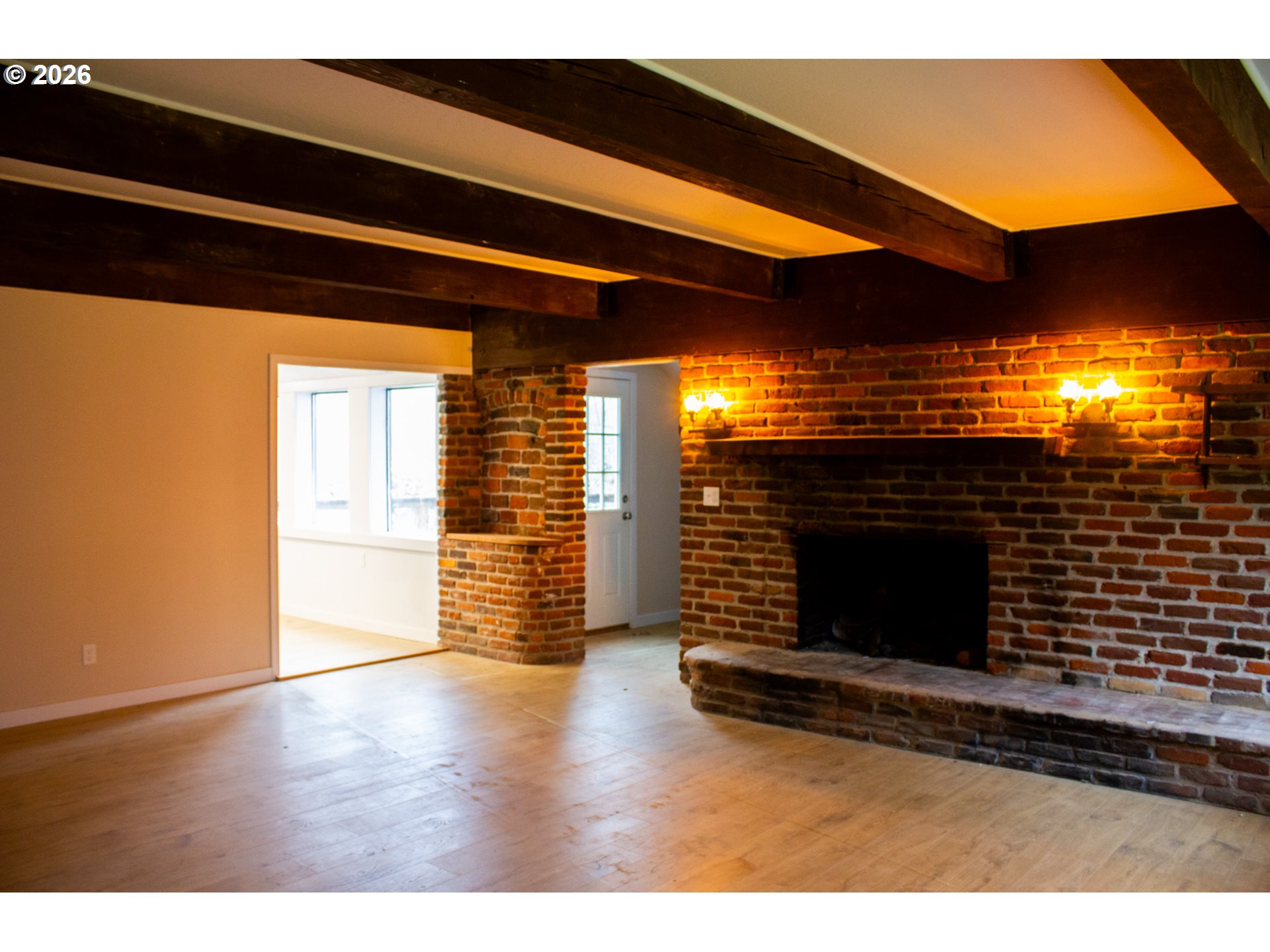 411 Upper Terrace Lane Glide, OR 97443 - Photo 5 of 25 a view of an empty room with wooden floor and a fireplace