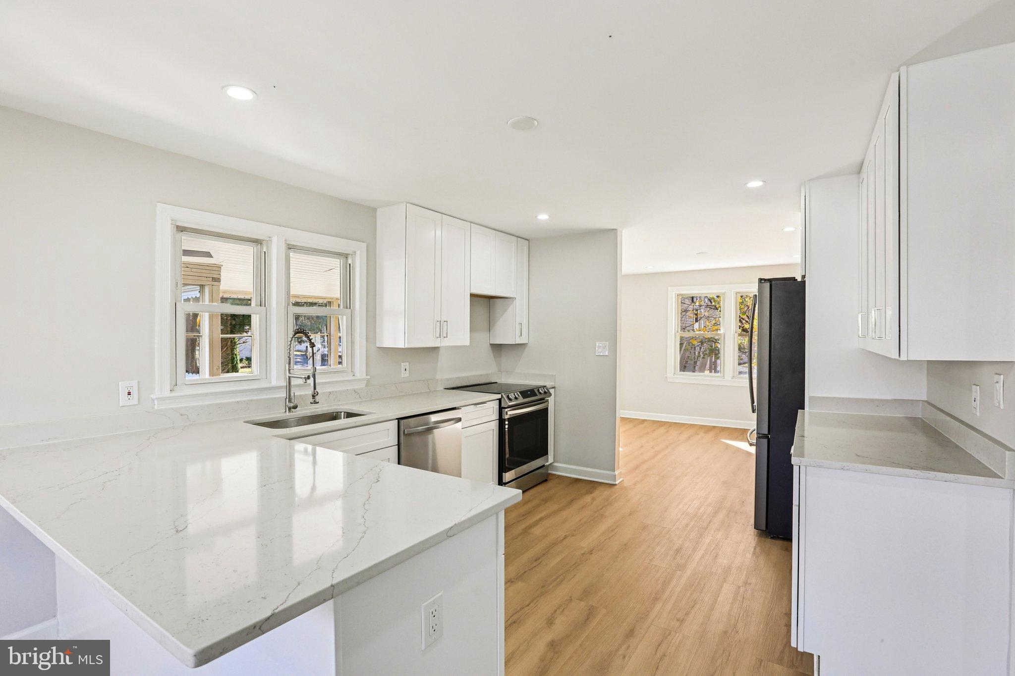 10571 Scaggsville Road Laurel, MD 20723 - Photo 14 of 60 a kitchen with stainless steel appliances granite countertop a stove and a sink